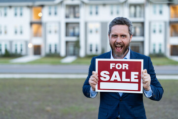 sale property by amazed broker hold board with copy space outdoor