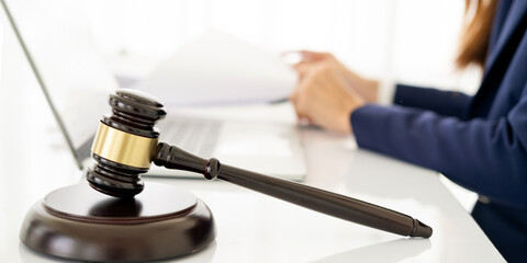 Focus closeup wooden gavel on blurred background of lawyer colleagues or legal team working at law...