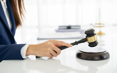 Focus closeup wooden gavel on blurred background of lawyer colleagues or legal team working at law firm office. Hammer of justice for righteous and equality judgment. Equilibrium