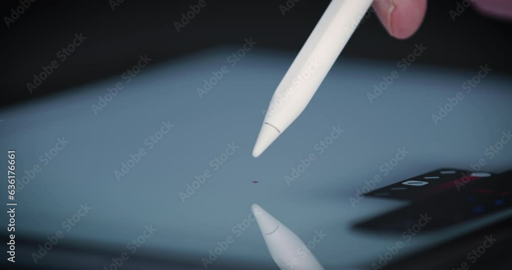 Poster writing with stylus on tablet screen to add digital note