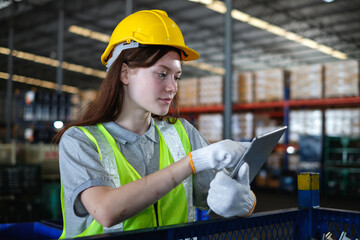 Female industrial engineer using tablet to inspect auto spare parts in the factory.Automobile industry and technology of warehouse.