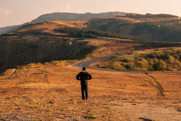 View of a tourist at a scenic view point at The Graet Rift Valley View Point, Mbeya, Tanzania