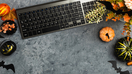 Laptop on a desk workspace with yellow leaves and pumpkins