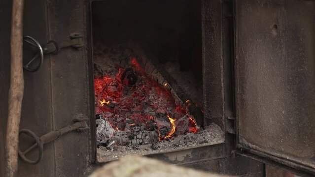 Open wood burning stove. Close-up of oven with open door, front view