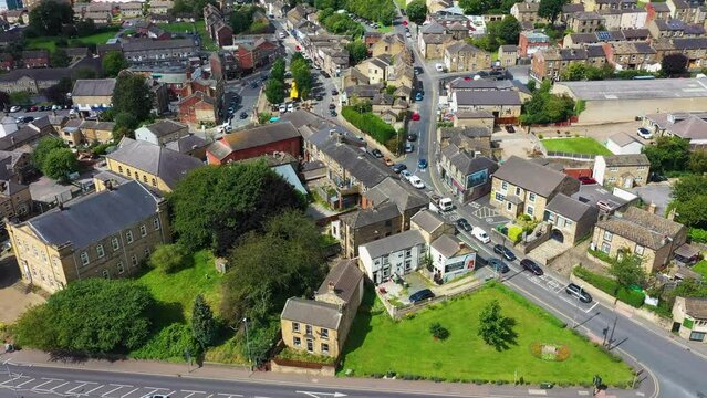 Aerial footage of the beautiful historical town of Batley in the Metropolitan Borough of Kirklees, West Yorkshire, England showing the historical town centre and market stalls in the summer