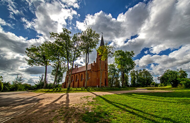 General view and close-up architectural details of the Catholic Church of St. Holy Trinity in the town of Dwawrzuty in Masuria in Poland.