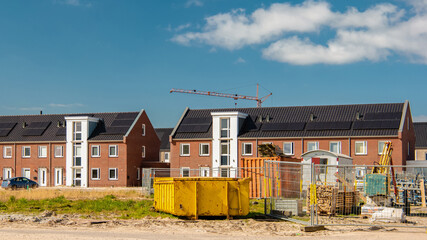 Dutch Suburban area with modern family houses, newly built modern family homes in the Netherlands, Building site in a new neighborhood, construction site in the Netherlands