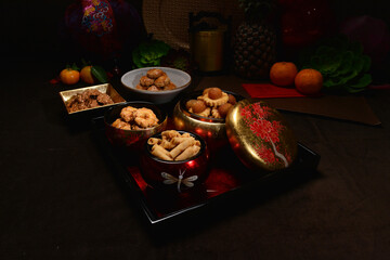 Chinese new year festival freshly baked assorted crispy cookies set with pineapple tart, almond,...