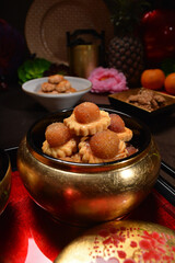 Chinese new year festival freshly baked assorted crispy cookies set with pineapple tart, almond, chocolate , coconut walnut, peanut and spicy shrimp floss roll in luxury asian red gold platter design