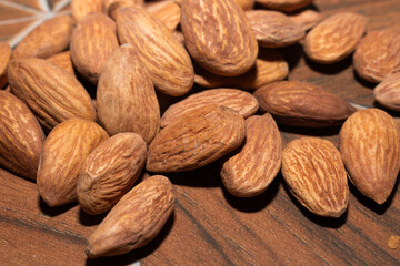 Almonds on brown wooden background