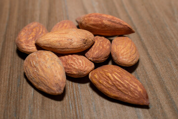 Almonds on brown wooden background