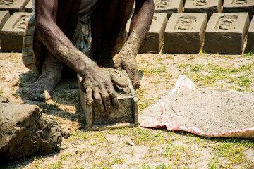 5th June, 2023, Burul, West Bengal, India: Traditional man made brick industry worker making bricks...