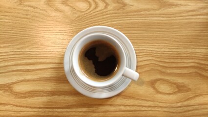 Coffee cup top view on wooden table background