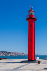 Farol de Cacilhas, Red lighthouse in the port of Almada, located on the southern margin of the...