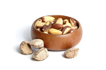 Brazil nuts in wooden bowl isolated on white background. Brazil nut kernels, a tasty choice