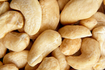 Cashew nut heap as food texture background, macro shot. Vegan friendly and tasty, top view