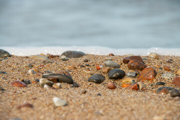 Close-up view of the sand with small stones on the seashore