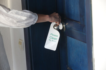 Hotel door hanger. Please clean my room tag hanging in the dor knob.
