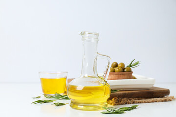 Olive oil and olives on white background
