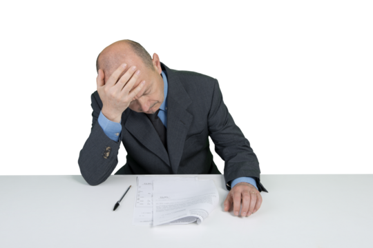 a desperate businessman in front of a contract to be signed