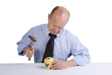 a middle-aged man breaking the piggy bank