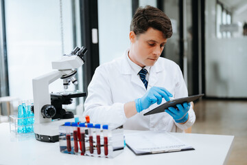 Modern medical research laboratory. female scientist working with micro pipettes analyzing...