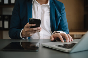 Man hand using tablet ,laptop, and holding mobile with credit card online banking payment shopping