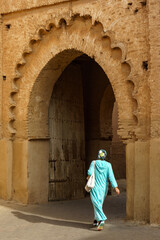 Morocco. Taroudant. A woman in a chador in front of the Bab Sedra gate of the city walls