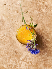Jar of organic multifloral honey with cornflower and catnip. Healthy and natural food ingredients