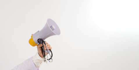 Megaphone and stethoscope in doctor's hand on white background.