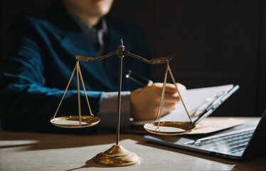 Business and lawyers discussing contract papers with brass scale on desk in office. Law, legal...