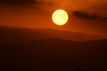 The sun setting behind the mountains