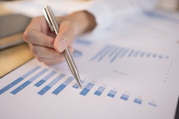 Asian businesswomen are analyzing graphs, financial statistics and calculating corporate returns in private offices, Market research reports and income statistics, Financial and Accounting concept.