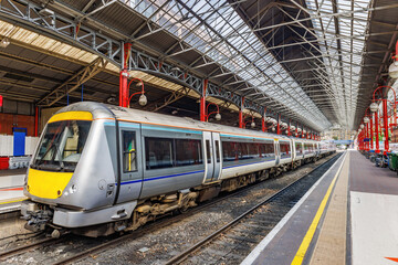A commuter train at the railway platform about to leave the station