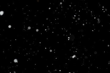 Bokeh effect of snowfall and lights. Abstract blurred background with snowflake in the night sky,...