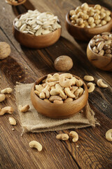 DRİED NUTS AND FRUİTS IN WOODEN BOWL ON BROWN FLOOR