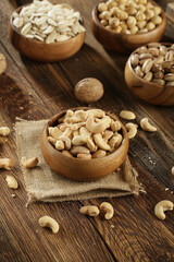 Fototapeta premium DRİED NUTS AND FRUİTS IN WOODEN BOWL ON BROWN FLOOR