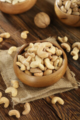 DRİED NUTS AND FRUİTS IN WOODEN BOWL ON BROWN FLOOR
