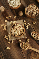 DRİED NUTS AND FRUİTS IN WOODEN BOWL ON BROWN FLOOR