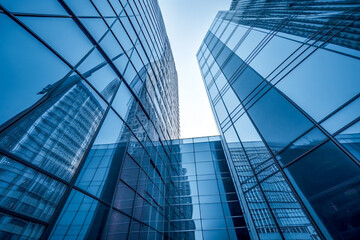 Fototapeta na wymiar Looking up at a blue modern office building