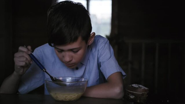 Savoring Nourishment: Close-Up of Boy Enjoying Soup in the Evening at Home