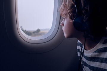 Boy looking out plane window