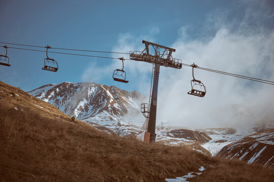 Cable car in mountainous terrain with snowy slopes
