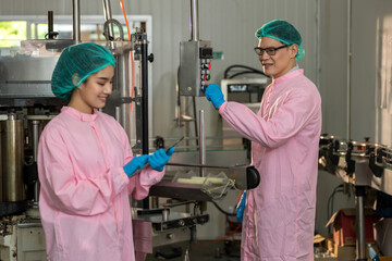 Food factory. Factory inspector controlling production. supervisor or worker using Checking quality or checking stock of products in beverage factory. Worker QC working in a drink water factory