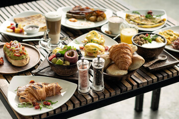 many mixed western breakfast food items on cafe table - 636266414