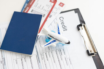 Toy plane and arrival card on white table. Travel insurance