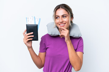 Young pretty Uruguayan woman with Inflatable Travel Pillow isolated on white background looking to the side and smiling