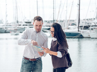 Man showing route on map to woman
