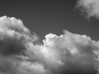 Obraz premium White clouds over sky black and white background. Fluffy cumulus clouds shape