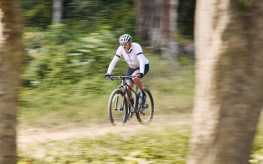 Fototapeta premium Forest blur, mountain bike and sports man cycling, action and ride bicycle for cardio, fitness or transportation. Sustainable, green nature trees and cyclist training, speed and travel in woods path
